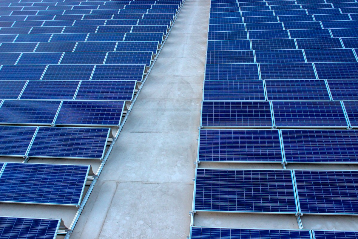 Rows of photovoltaic solar panels for net-zero energy infrastructure
